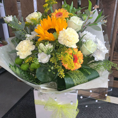 Bright Ideas - Beautiful Sunflowers and a peppering of other summer flowers and foliage. Tied in water and presented in a stylish bag. An amazing bouquet full of joy and delight ready to display and enjoy.    